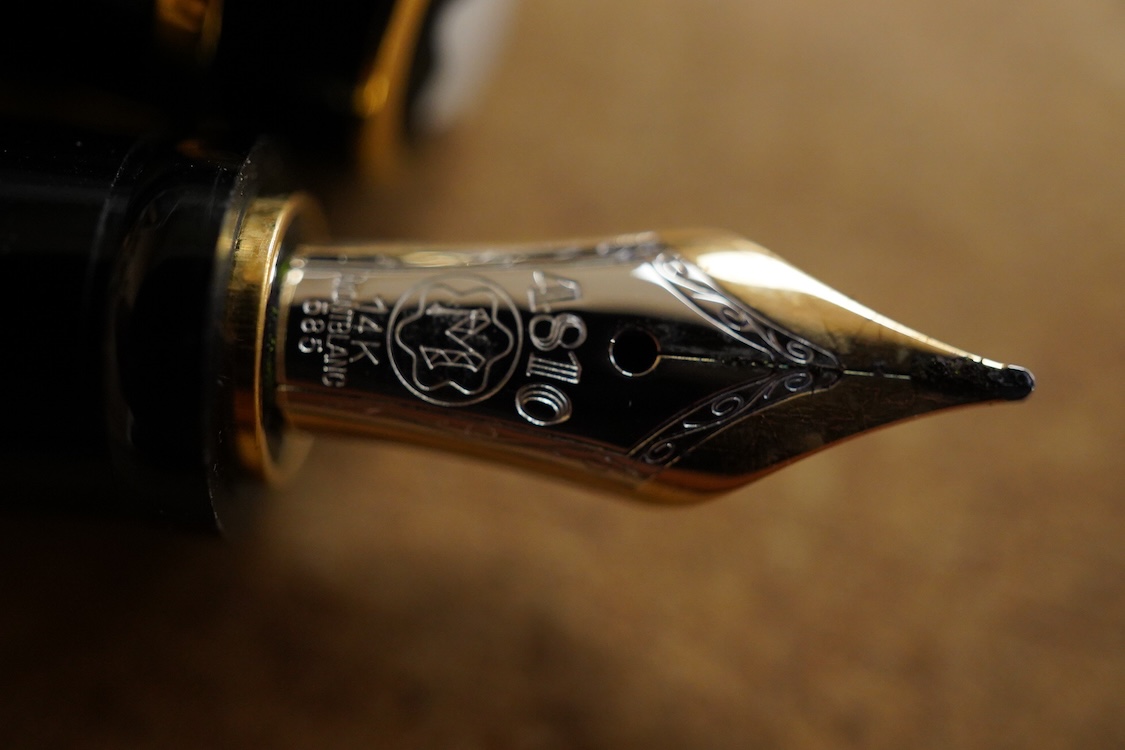 A leather cased Mont Blanc pen with retractable nib and decorative jewelled clip, 11cm long